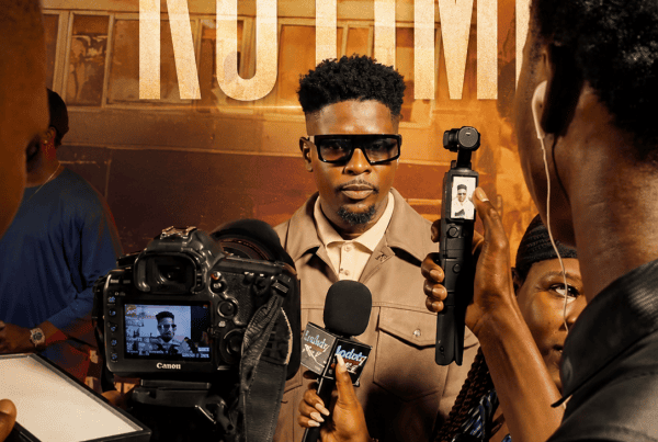 Rotimi Salami speaks with entertainment journalists during the NJEM movie premiere.